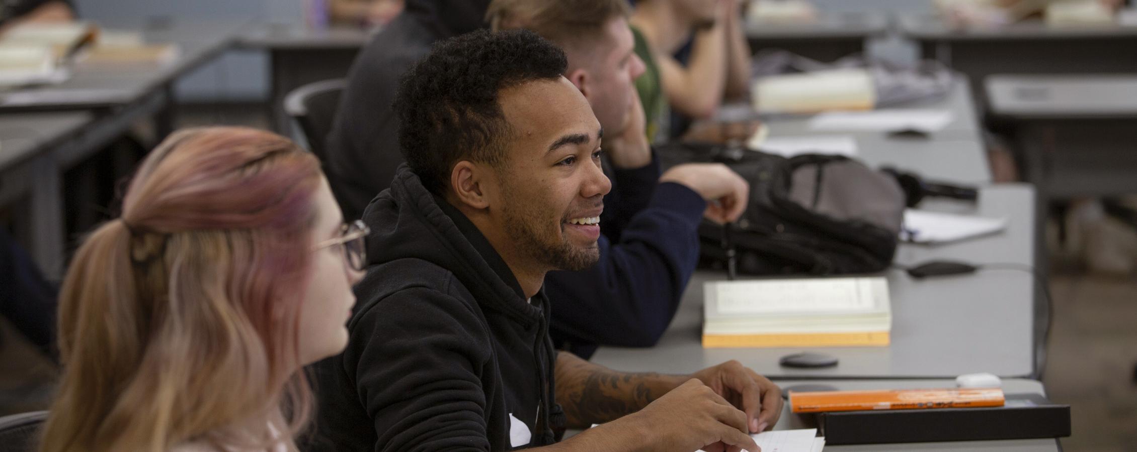 students listen and smile in a classroom