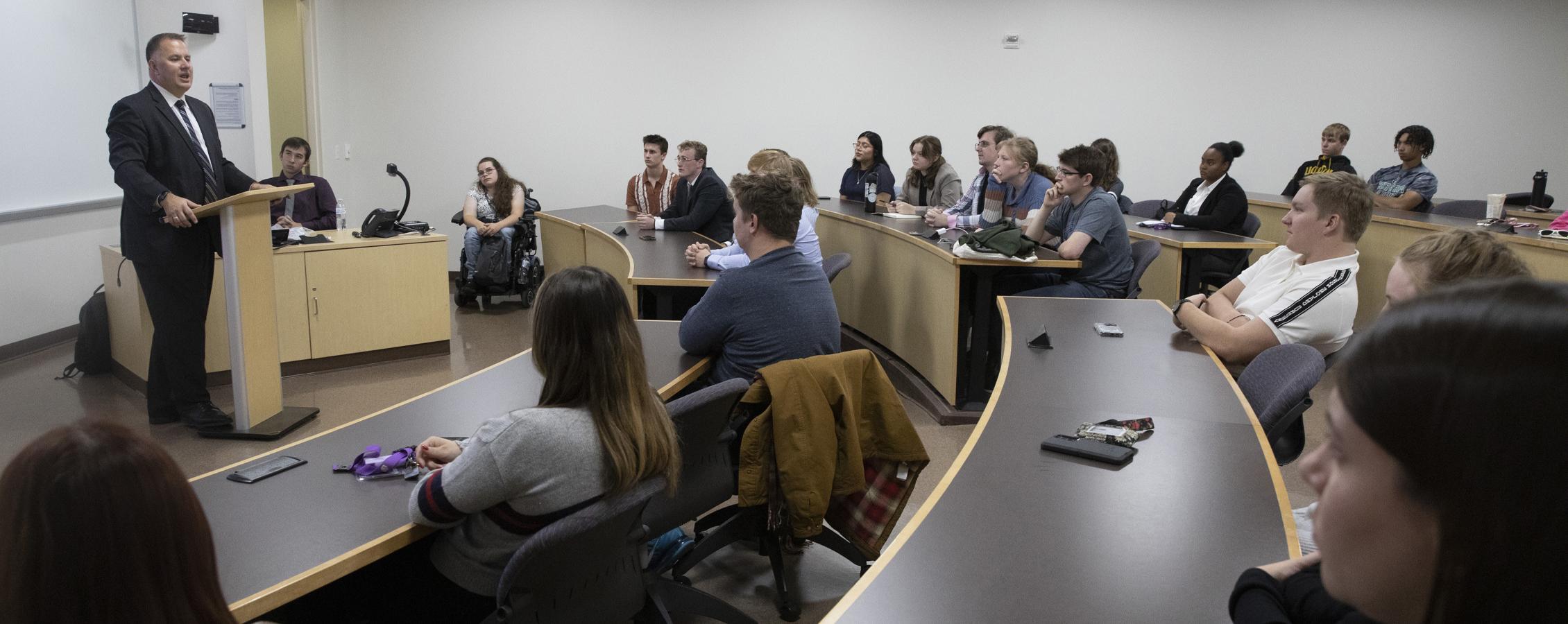 A judge speaks to students in a Hyland Hall classroom.