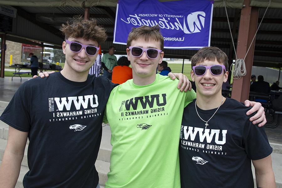 Three students with their arms around each other's shoulders wearing shirts that say UWW.