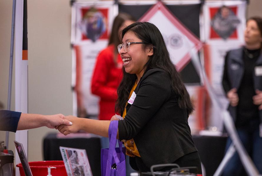 Student talking to recruiters at the University of Wisconsin-Whitewater campus career fair.