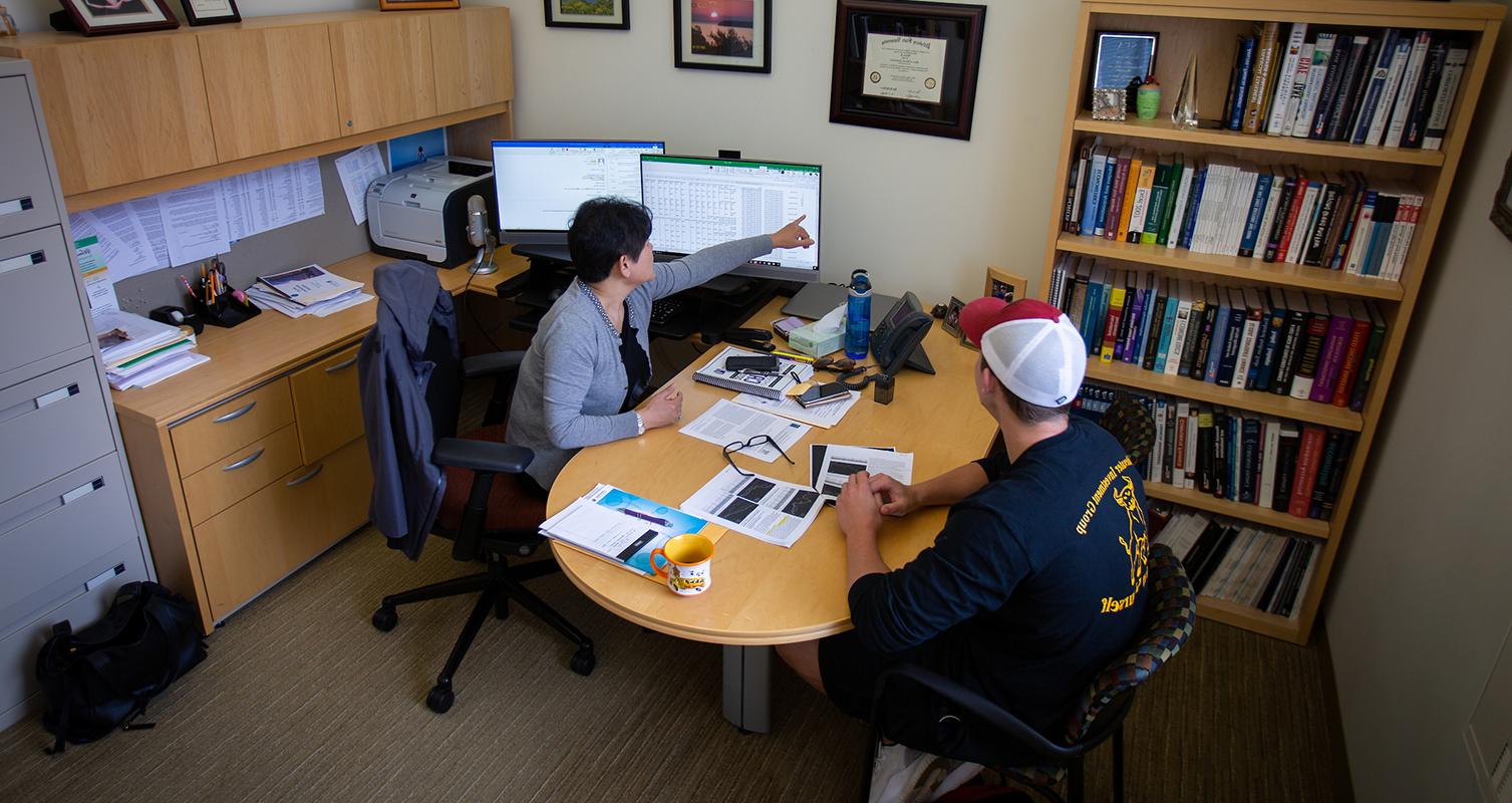 Linda Yu, department chair and professor of finance, meets with a student on campus at 足彩平台.