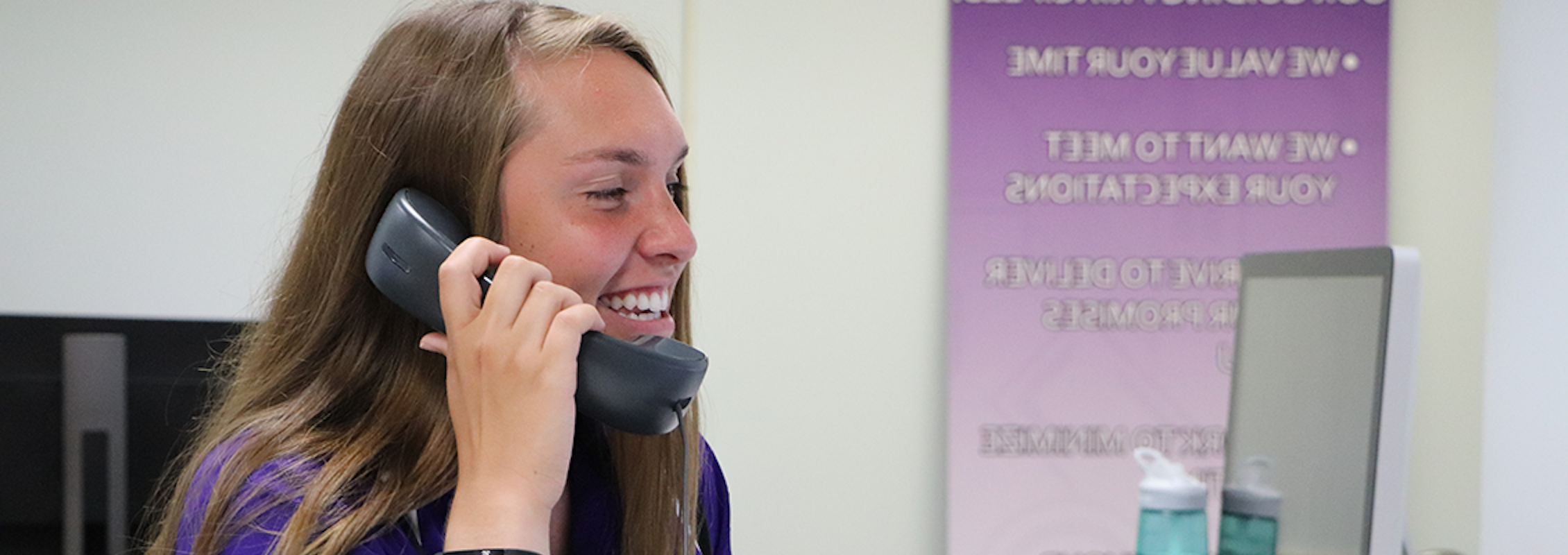 happy student employee answering a support call