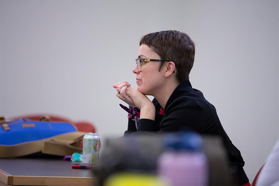 Stephanie Selvick listens to author and producer Jacob Tobia read from their book.