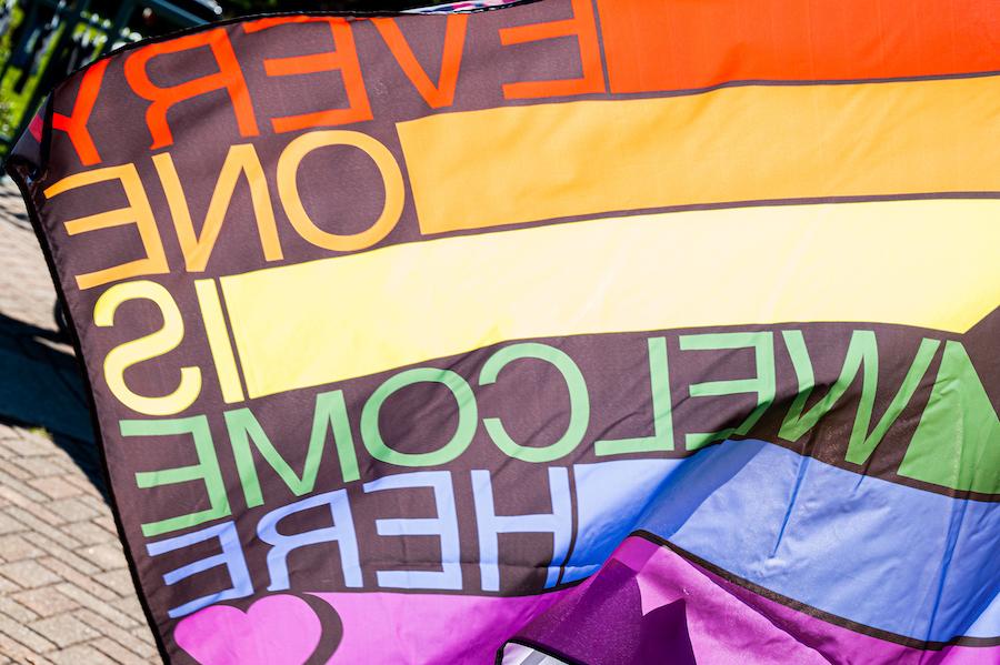 Image of a Pride Flag that states "Everyone is Welcome Here".